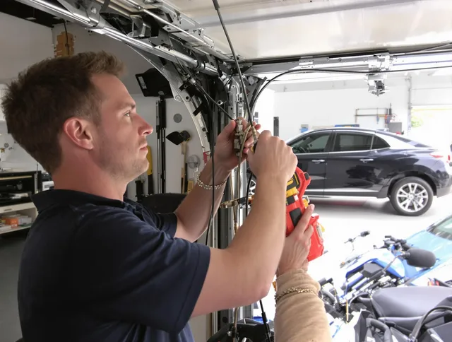 Seekonk Garage Door Repair safety certified technician performing cable replacement in Seekonk
